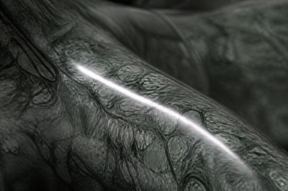 Deep green marble sculpture Collado, a reclining figure carved with its slab base from one block of veined green stone.
