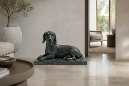 Deep green marble sculpture Collado, a reclining figure carved with its slab base from one block of veined green stone.