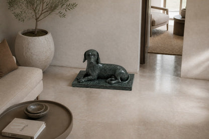 Deep green marble sculpture Collado, a reclining figure carved with its slab base from one block of veined green stone.