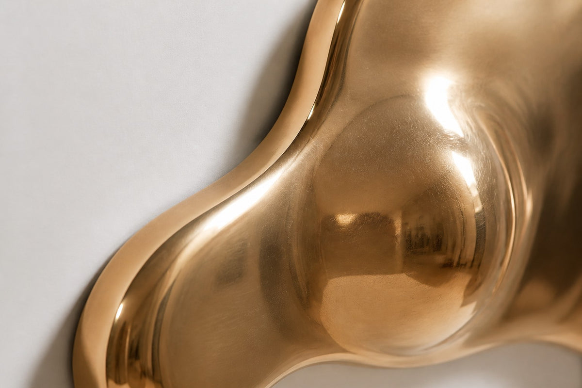 Crisol — polished champagne bronze molten pool wall sculpture, close detail of the surface and edge