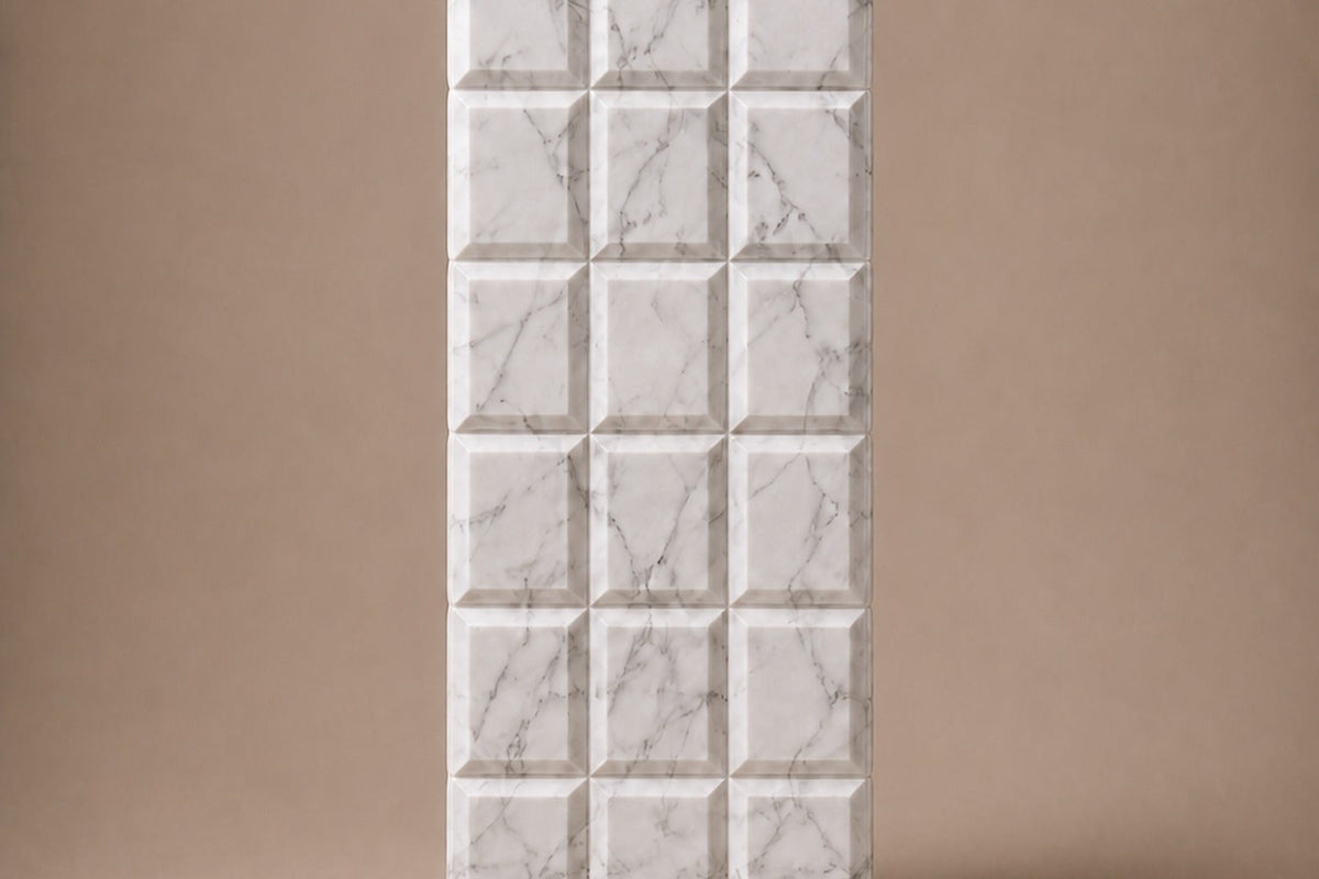 Tall white Carrara marble column carved into a grid of raised cushioned panels — front elevation