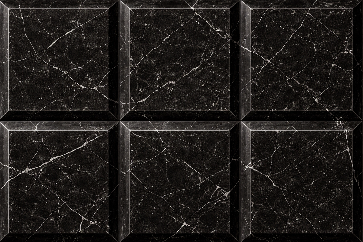 Tall black Nero Marquina marble column carved into a grid of raised cushioned panels — close detail of the surface