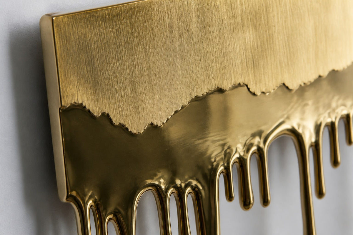 Deshielo — brass sheet wall sculpture melting into drips, close detail of the surface and edge
