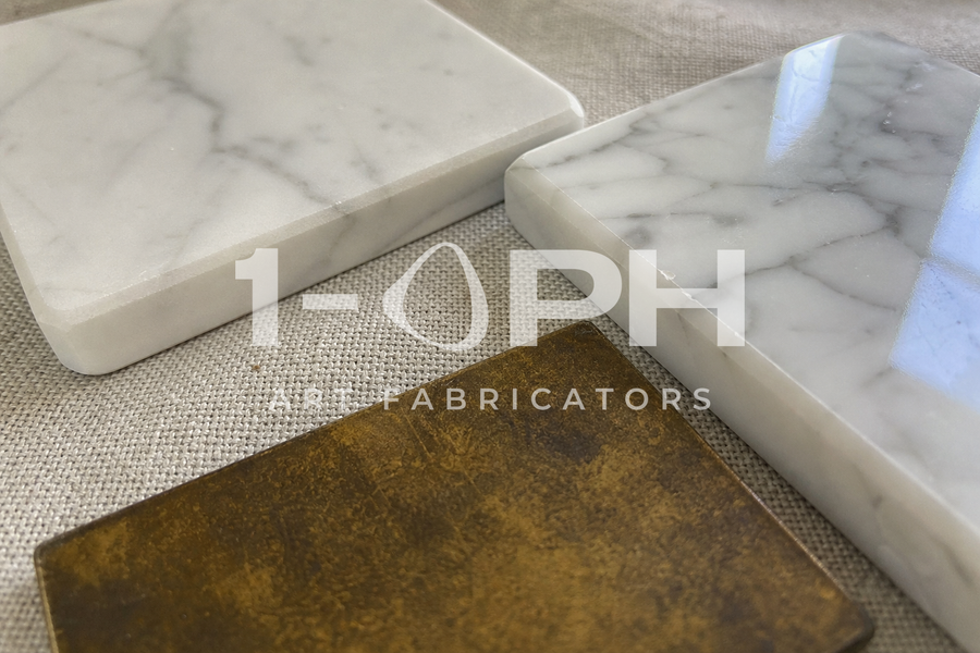 Marble and bronze finish samples under project light