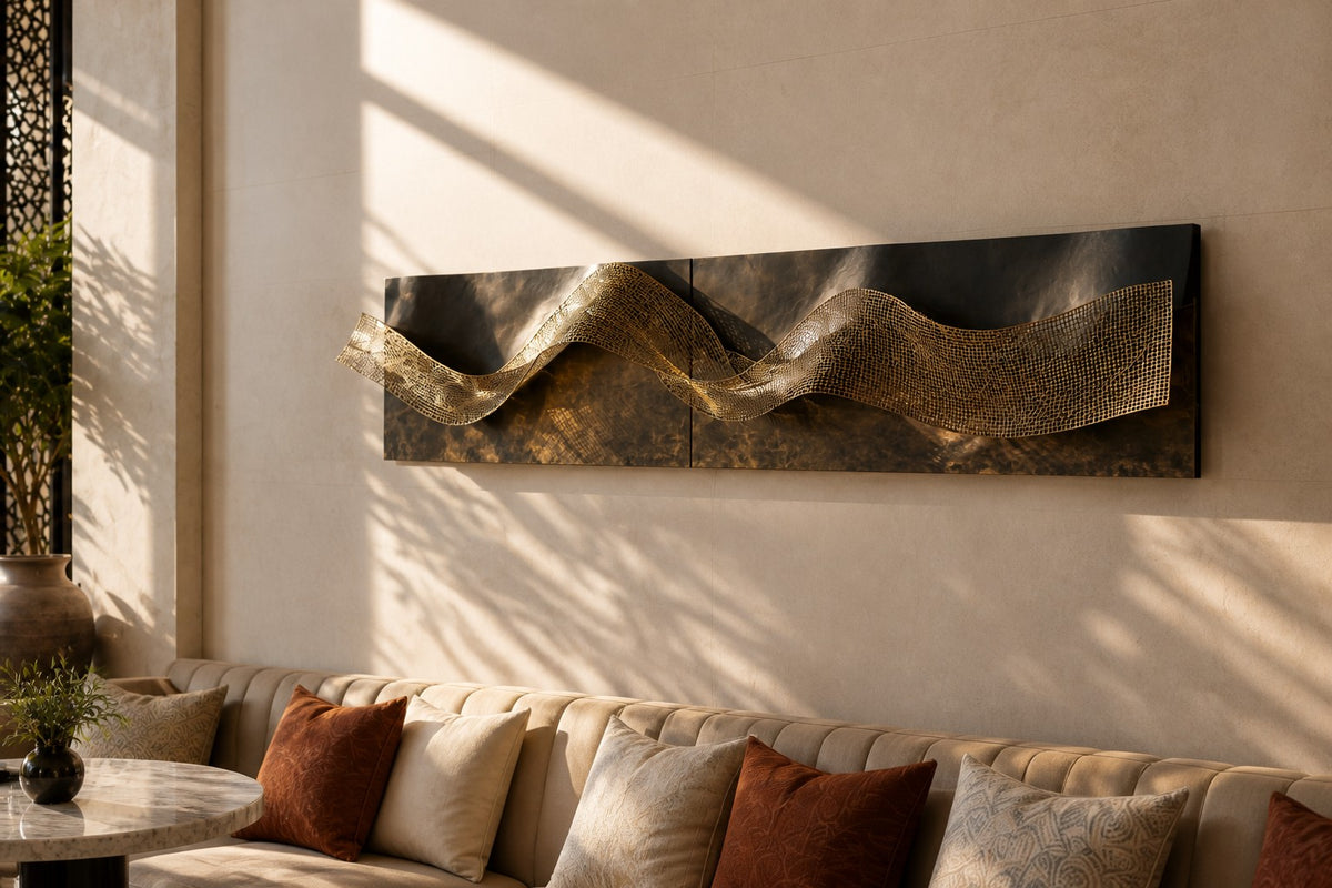 Dobra — folded dark bronze wall sculpture with a brass mesh wave, close view on the wall