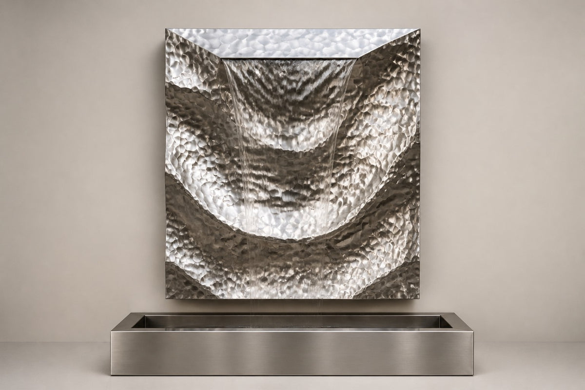 Drift — hammered stainless panel wall fountain, studio front view