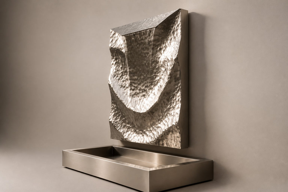 Drift — hammered stainless panel wall fountain, studio side angle showing its depth