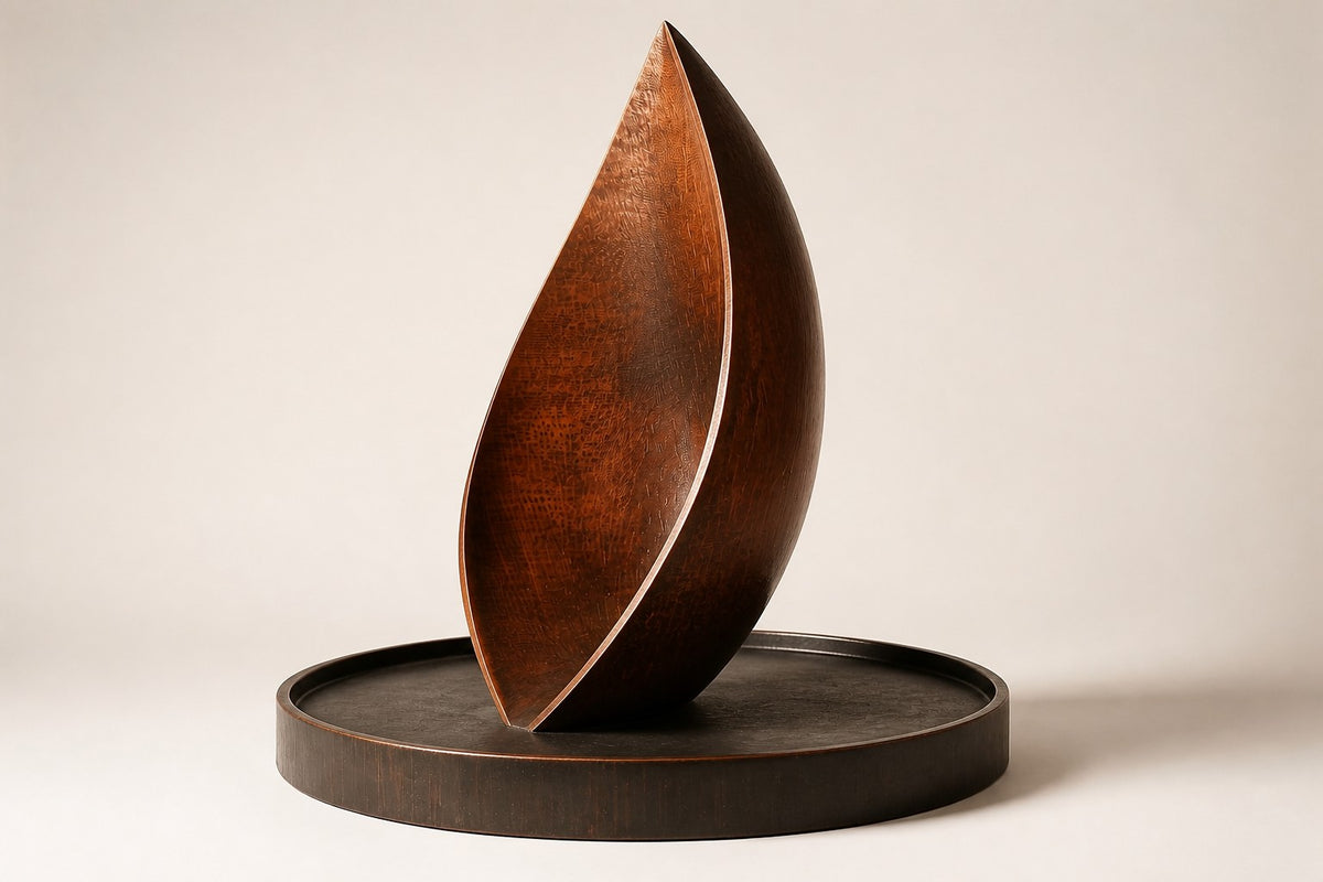 EMBER / RISE I — 200 cm leaf-shaped Corten steel water feature in a round stone basin, three-quarter studio view showing its profile