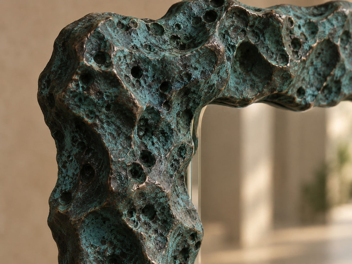 Estanque — 110 × 200 cm tall standing mirror with a rough cast frame in blue-green patinated bronze, close studio detail of the surface and material