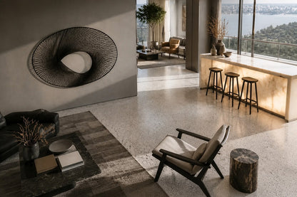 Elliptical woven-wire form twisting into a saddle, in charcoal and silver-grey.