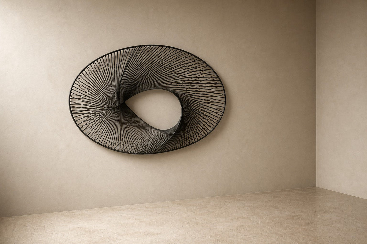 Falak — 180 × 110 cm brushed steel wire wall sculpture woven into a twisted ring, three-quarter studio view showing its profile