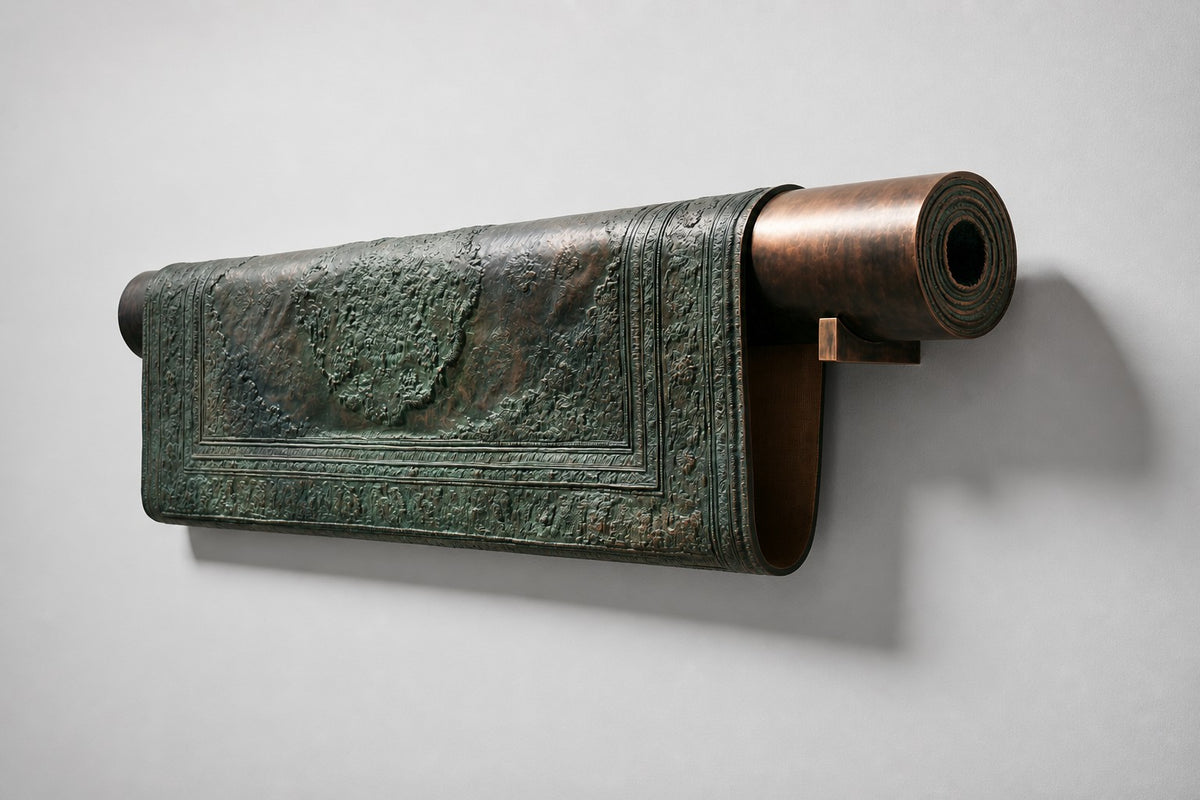 Farsh — patinated bronze wall sculpture of a partly rolled Persian carpet, studio side angle showing its depth