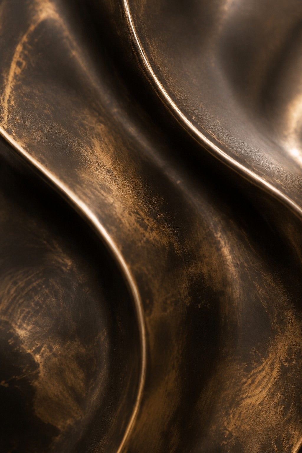 Fascia — 90 × 130 cm bronze wall relief of a folded oval ribbon, close studio detail of the surface and material