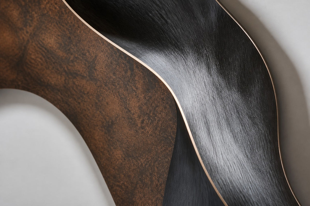 Figura — bronze and copper circular wall sculpture with a woman's profile, close detail of the surface and edge