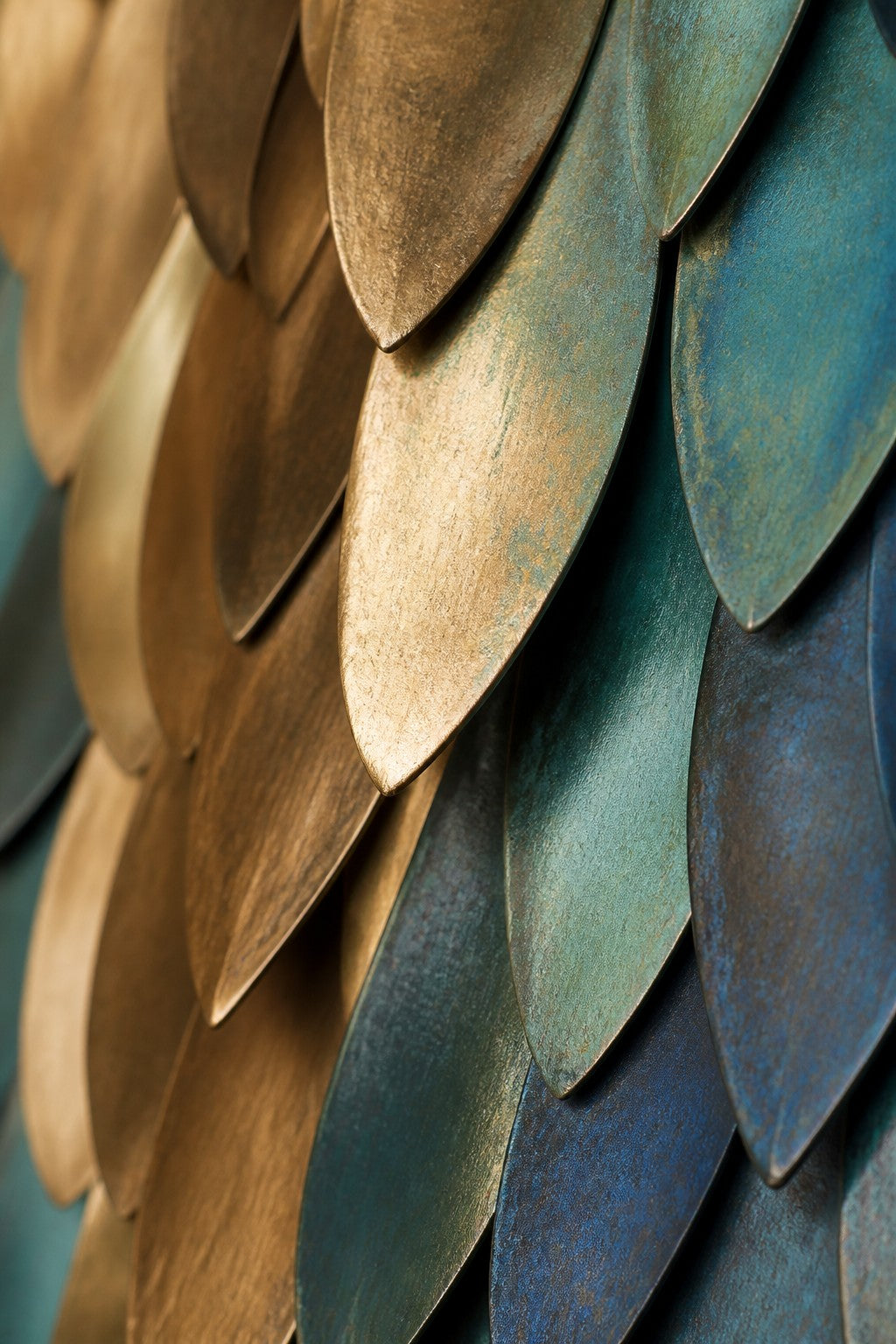 Firuz — 90 × 180 cm diamond-shaped wall sculpture of teal enamel and gold scales on a central spine, close studio detail of the surface and material