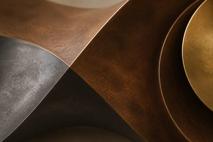 Long undulating bronze ribbon with a nested bowl and polished gold dome at its centre.