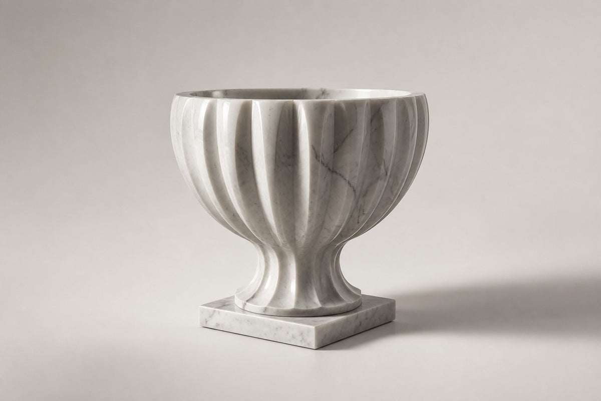 Fluted Marble Urn Planter — 70 cm white marble urn planter carved in broad flutes with a scalloped rim, three-quarter studio view showing its profile