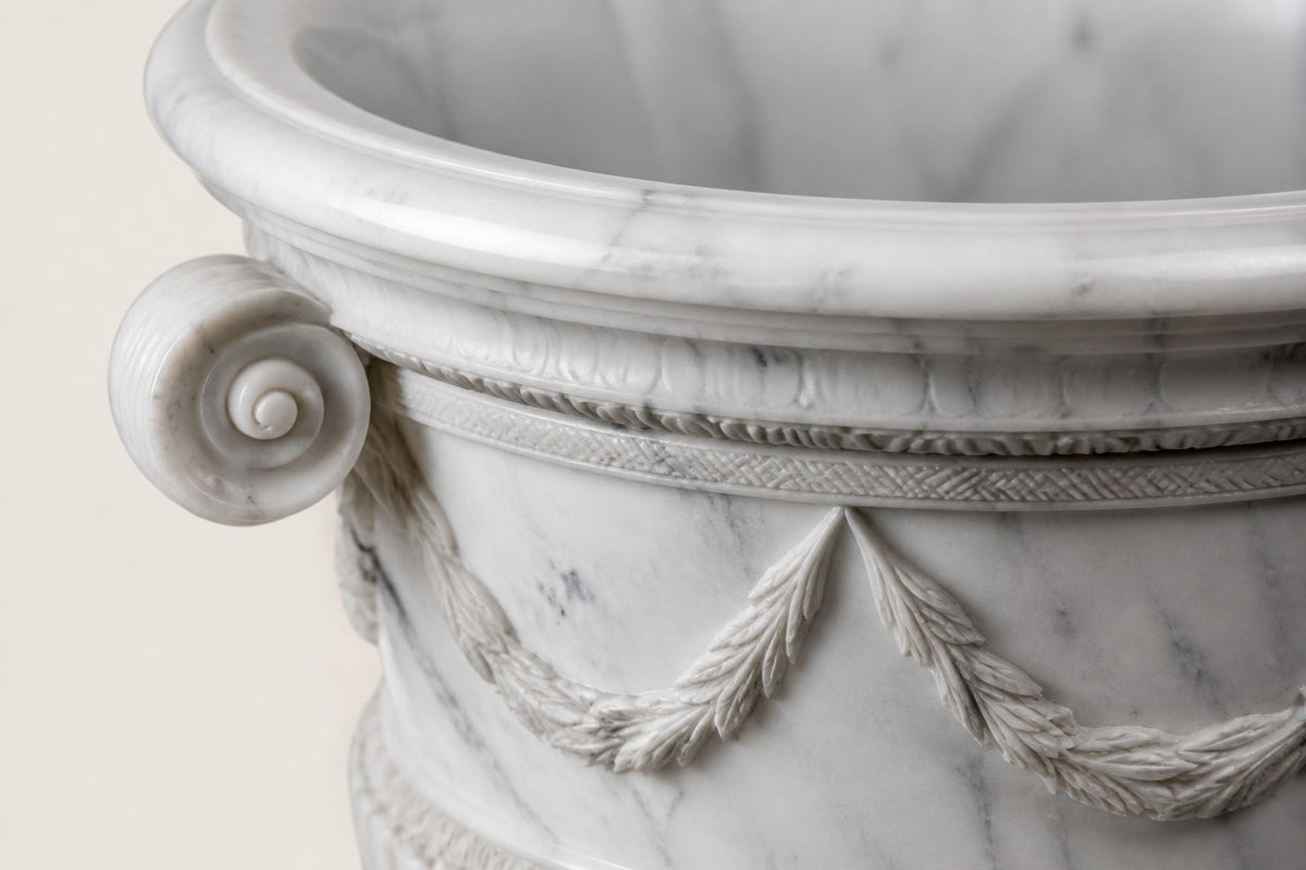 Garland Estate Marble Urn Planter — 105 cm white Carrara marble campana urn planter with a carved garland and scroll handles, close studio detail of the surface and material