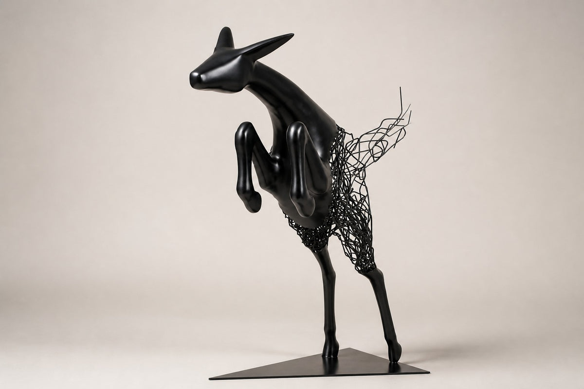 Ghazal — matte black stainless steel leaping antelope sculpture, studio side angle showing its depth