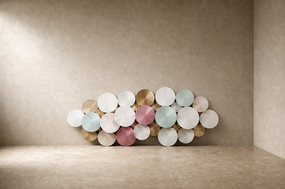 Cluster of overlapping spun discs in white, cream, sage and dusty pink with gilt accents.