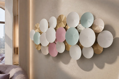Cluster of overlapping spun discs in white, cream, sage and dusty pink with gilt accents.