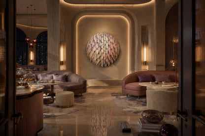 Cluster of overlapping spun discs in white, cream, sage and dusty pink with gilt accents.