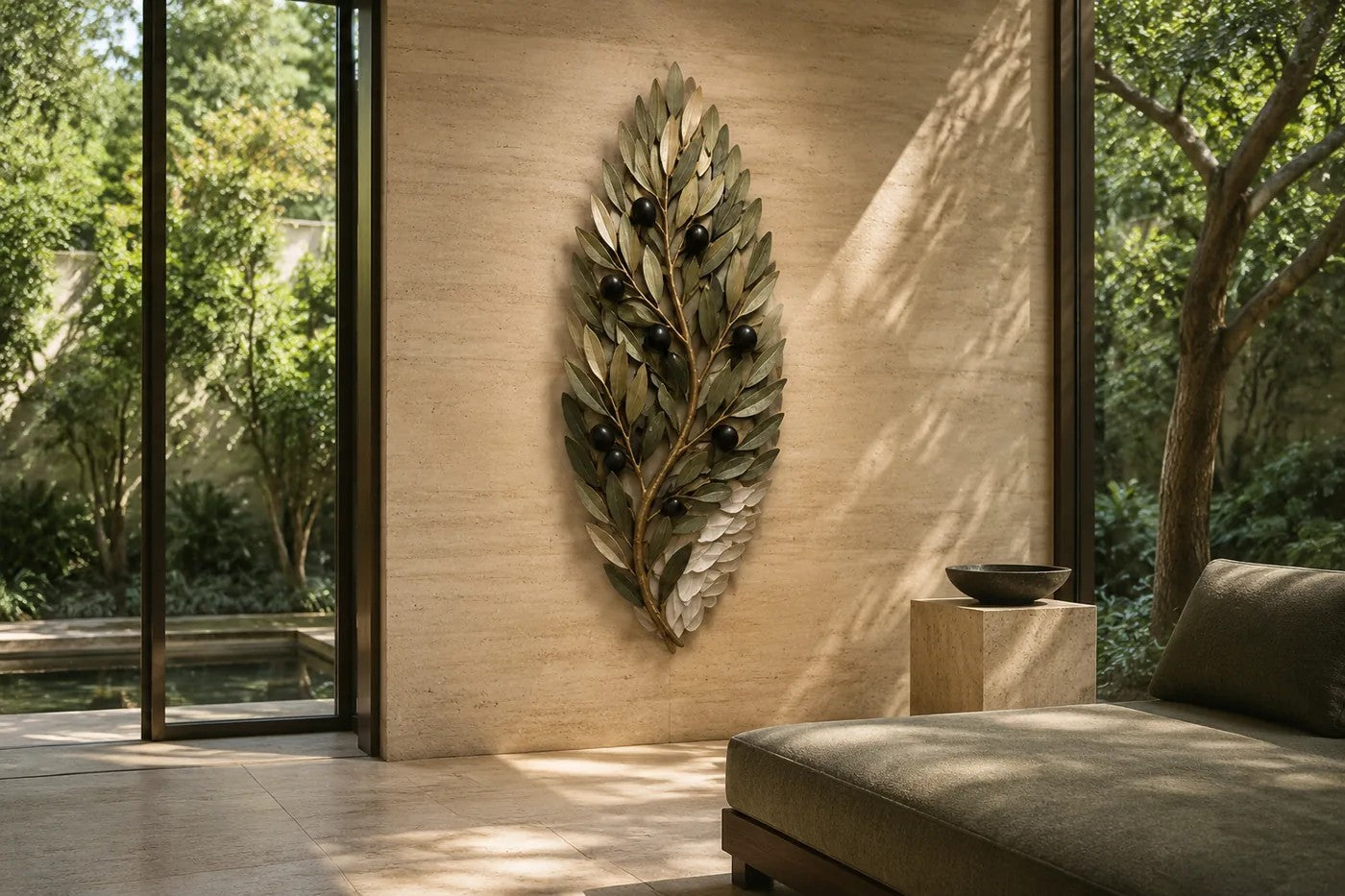 Olive green and dark bronze bronze wall sculpture Ramoscello, cast branch with individually mounted leaves and fruit, on a plaster wall.
