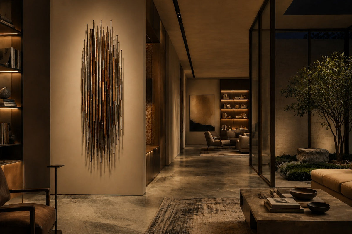 Giro — 80 × 160 cm vertical cluster of slender rods in steel, brass and timber, the same room at night, lamps on