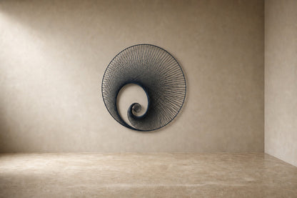 Deep indigo steel wall sculpture Chiocciola, fine wire wound across a circular rim into a spiral void, on a plaster wall.