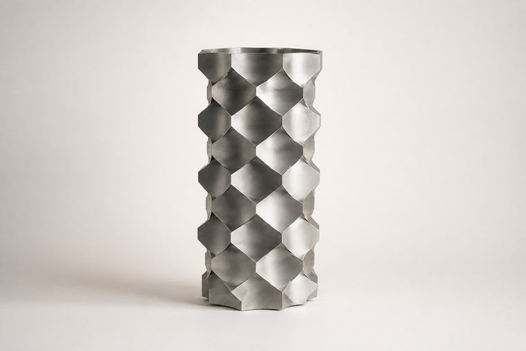 HexaFacet Stainless Steel Luxury Column Planter — 110 cm brushed stainless steel column planter with faceted honeycomb panels, studio view of the whole piece