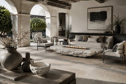 White quartzite fire table Himara 220, bright white with warm inclusions, on a pale stone floor.