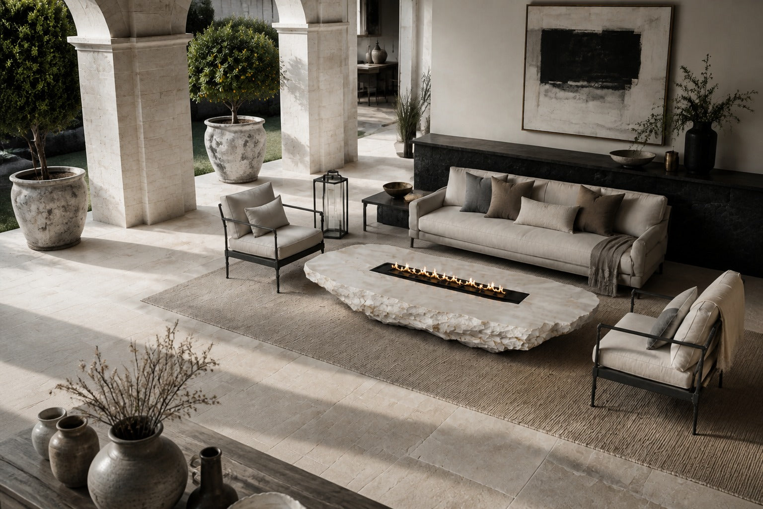 White quartzite fire table Himara 220, bright white with warm inclusions, on a pale stone floor.