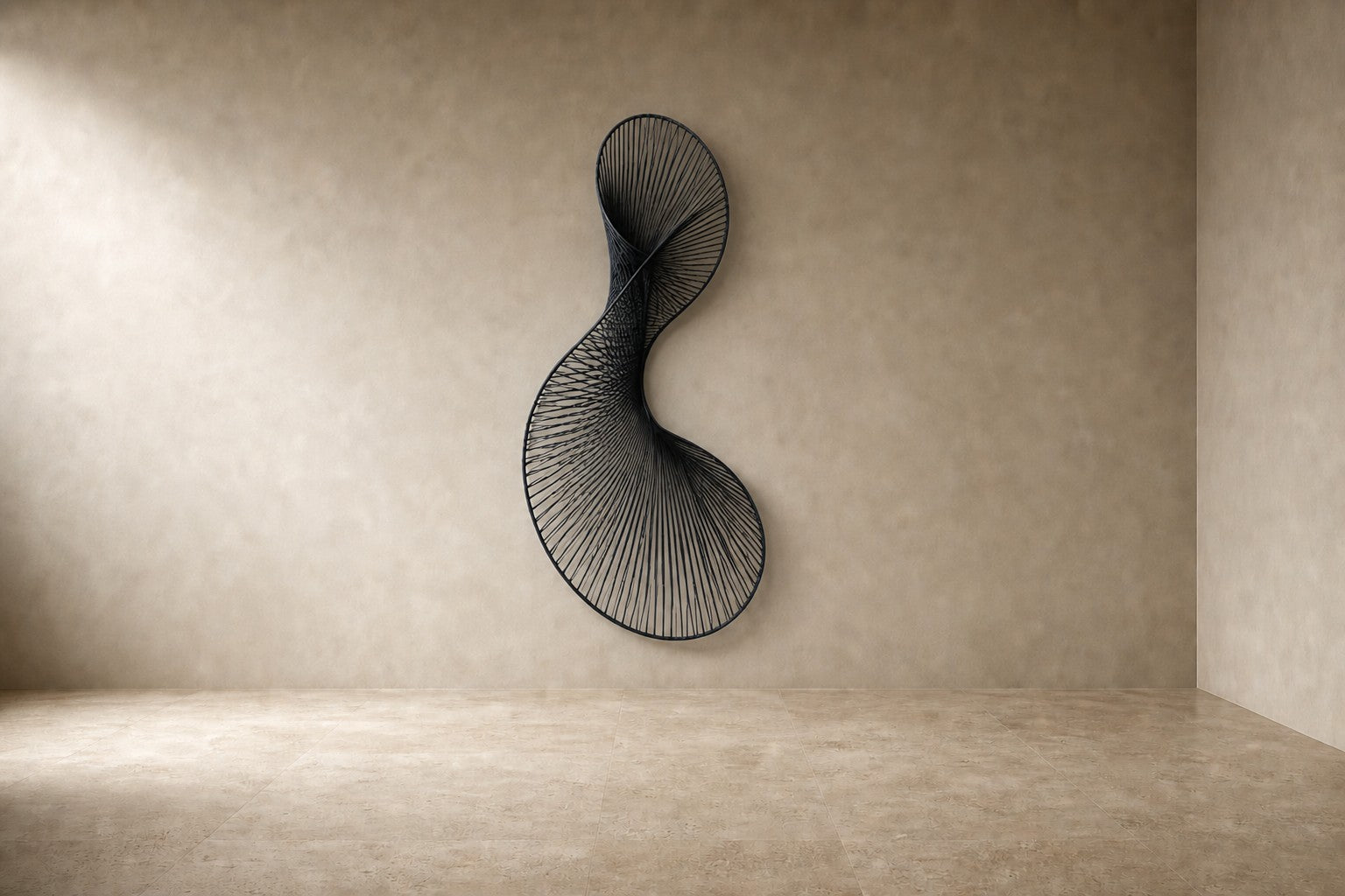Graphite steel wall sculpture Iltifat, a single sheet folded through itself in one continuous turn, on a plaster wall.
