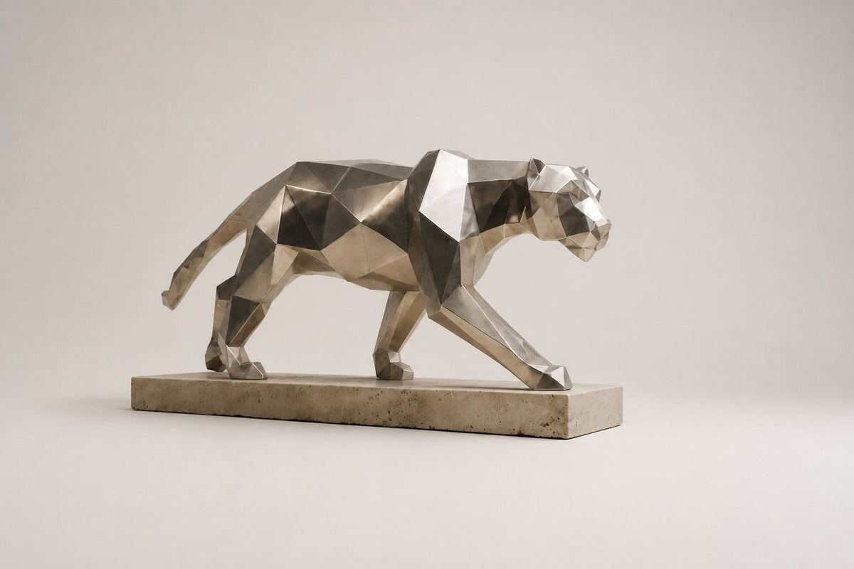 Imperial Stride Panther — 62 cm faceted stainless steel panther sculpture mid-stride on a travertine base, three-quarter studio view showing its profile