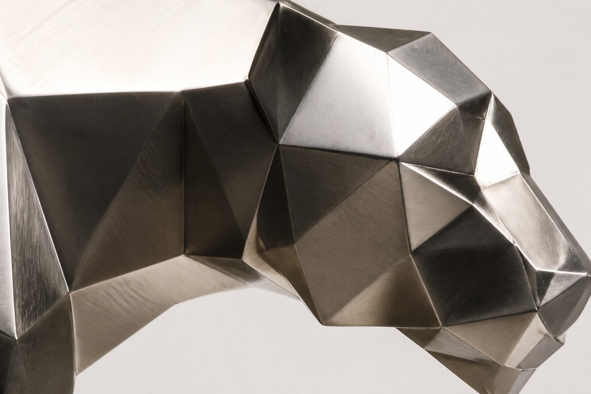 Imperial Stride Panther — 62 cm faceted stainless steel panther sculpture mid-stride on a travertine base, close studio detail of the surface and material