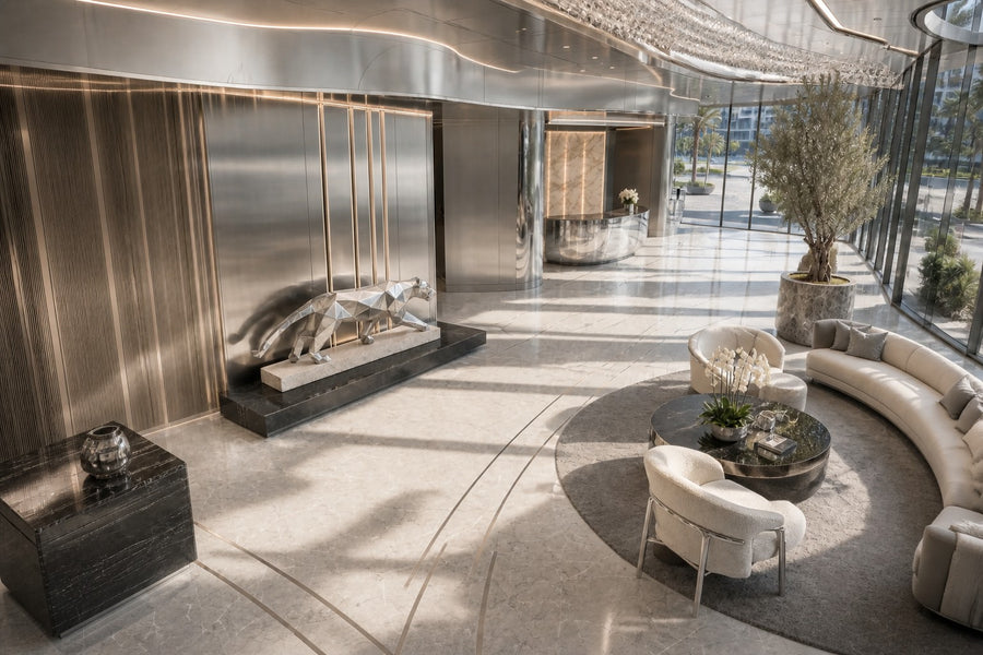 Imperial Stride Panther — 62 cm faceted stainless steel panther sculpture mid-stride on a travertine base, seen from above in the room
