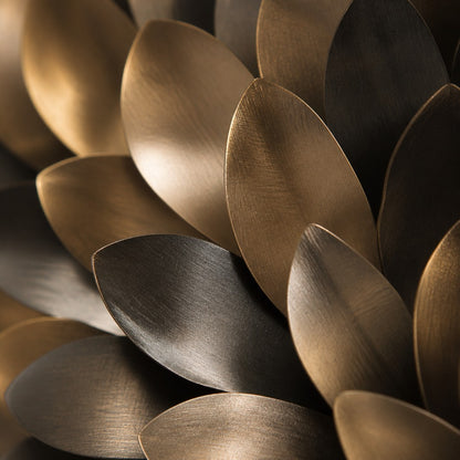 Dark bronze and pale gold bronze wall sculpture Collana, cast beads strung on a spun disc, on a plaster wall.