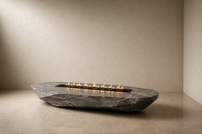 Grey-white marble fire table Iwana 220, grey-white with dark veining, on a pale stone floor.
