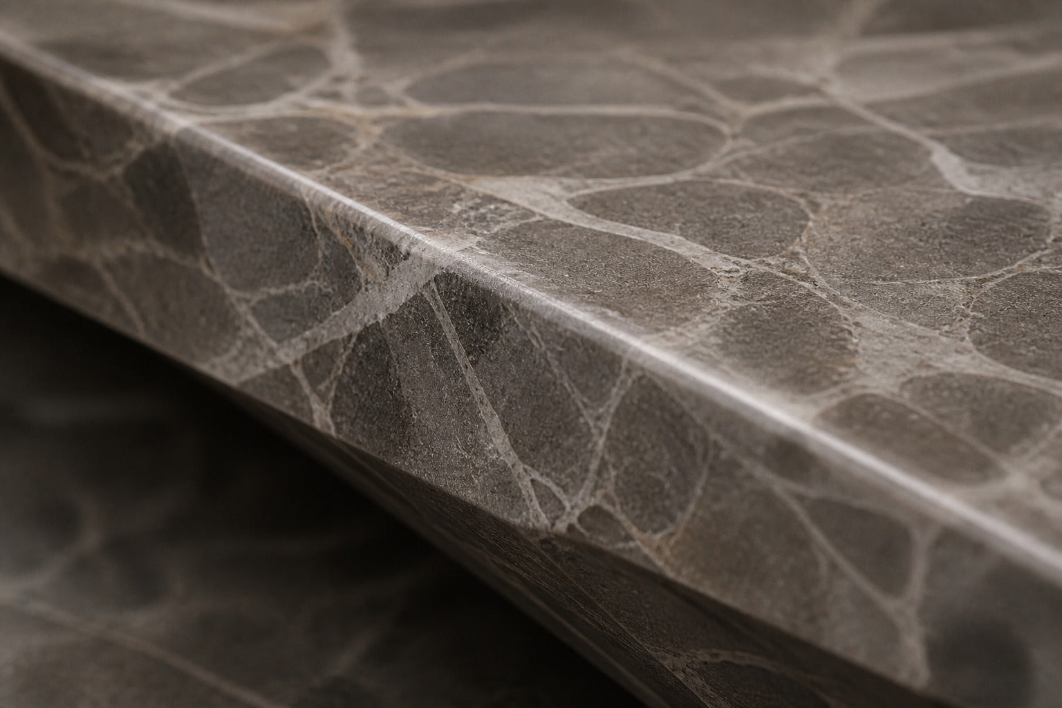 Grey-white marble fire table Iwana 220, grey-white with dark veining, on a pale stone floor.