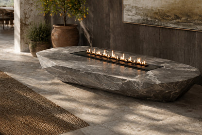 Grey-white marble fire table Iwana 220, grey-white with dark veining, on a pale stone floor.