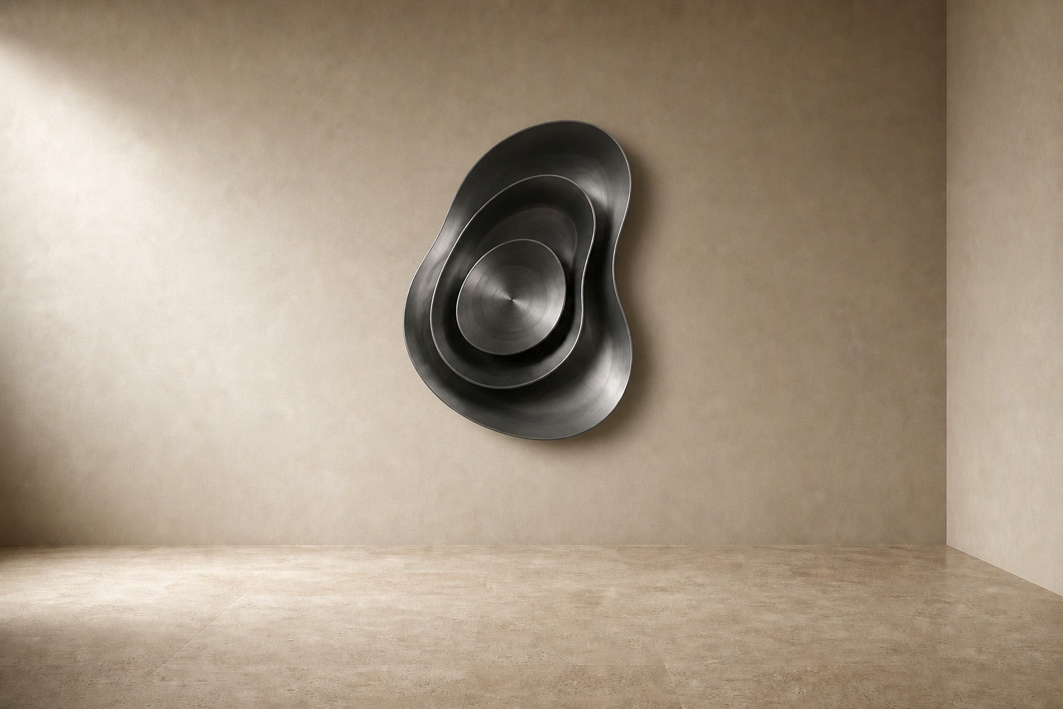 Iron grey bronze wall sculpture Roca, a cast boulder form mounted proud of a spun disc, on a plaster wall.