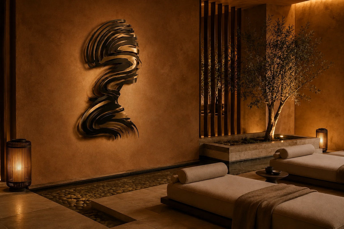 Jamuh 180 — 180 cm stainless steel wall sculpture of a human head in profile made of swirling black and bronze strokes, the same room at night, lamps on