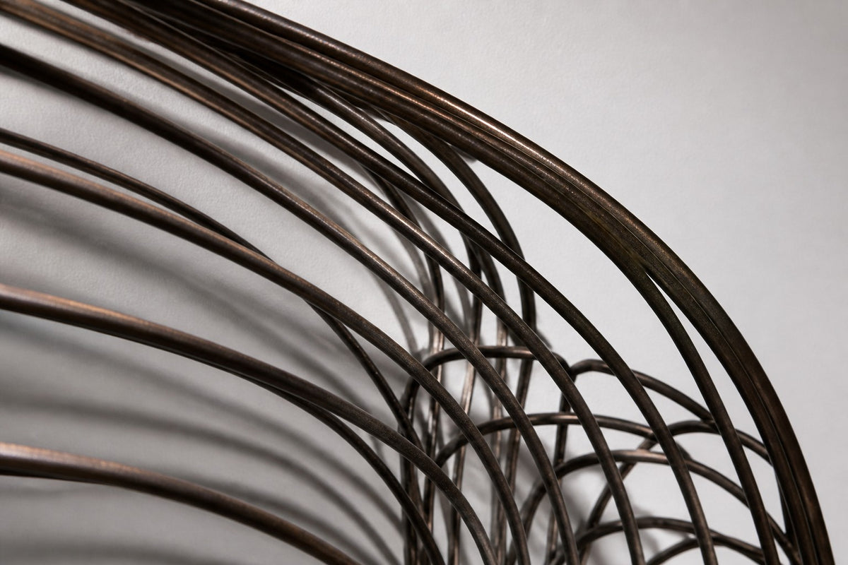 Janah — dark bronze wire wall sculpture of two outstretched wings, close detail of the surface and edge