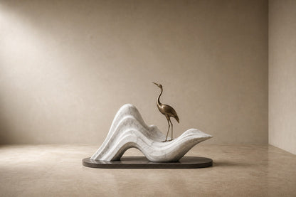 White marble wave sculpture Juncal in four crests with a slender bronze figure standing at the high point, on a dark granite oval base.