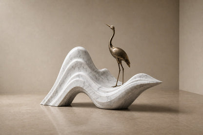 White marble wave sculpture Juncal in four crests with a slender bronze figure standing at the high point, on a dark granite oval base.