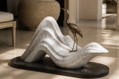 White marble wave sculpture Juncal in four crests with a slender bronze figure standing at the high point, on a dark granite oval base.