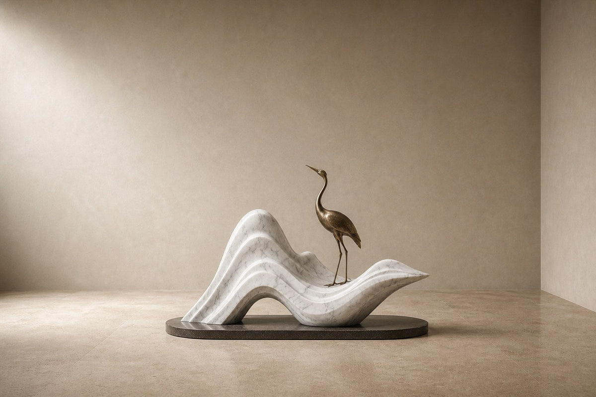 White marble wave sculpture Juncal in four crests with a slender bronze figure standing at the high point, on a dark granite oval base.