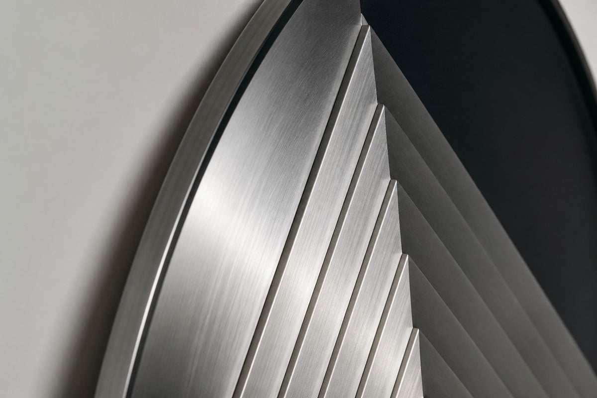 Kado — Ø 200 cm brushed stainless steel circular wall relief with a stepped diamond, close detail of the surface and edge