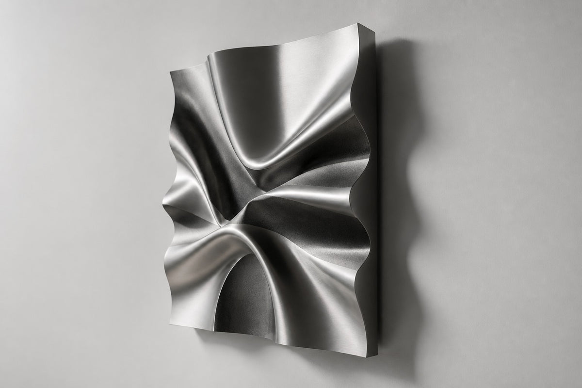 Kaze — satin stainless steel square wall sculpture rippling like wind, studio side angle showing its depth