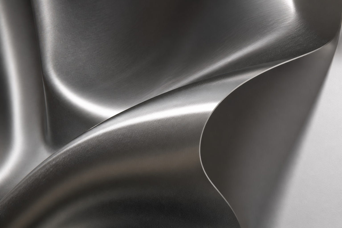 Kaze — satin stainless steel square wall sculpture rippling like wind, close detail of the surface and edge